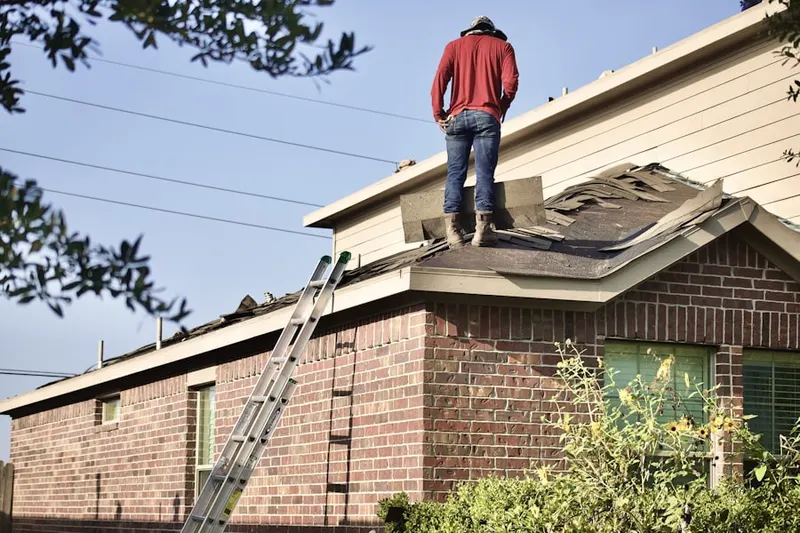 Professional roofer working on a residential roof in Manor Ridge Park